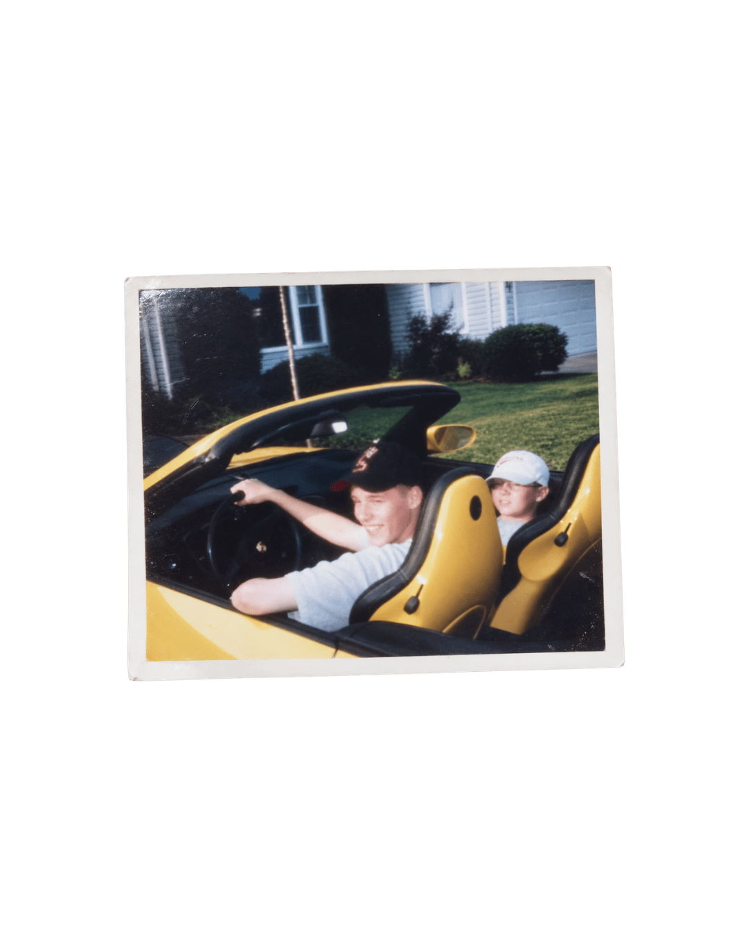 Two people riding in a yellow convertible
